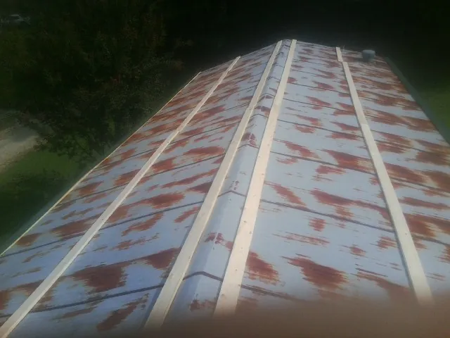 Rusted metal roof panels with new wood purlins before replacement — Storm Damage Roof Repair in Cupertino by Roofing Brothers